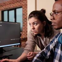 computer science tech engineer getting help from instructor