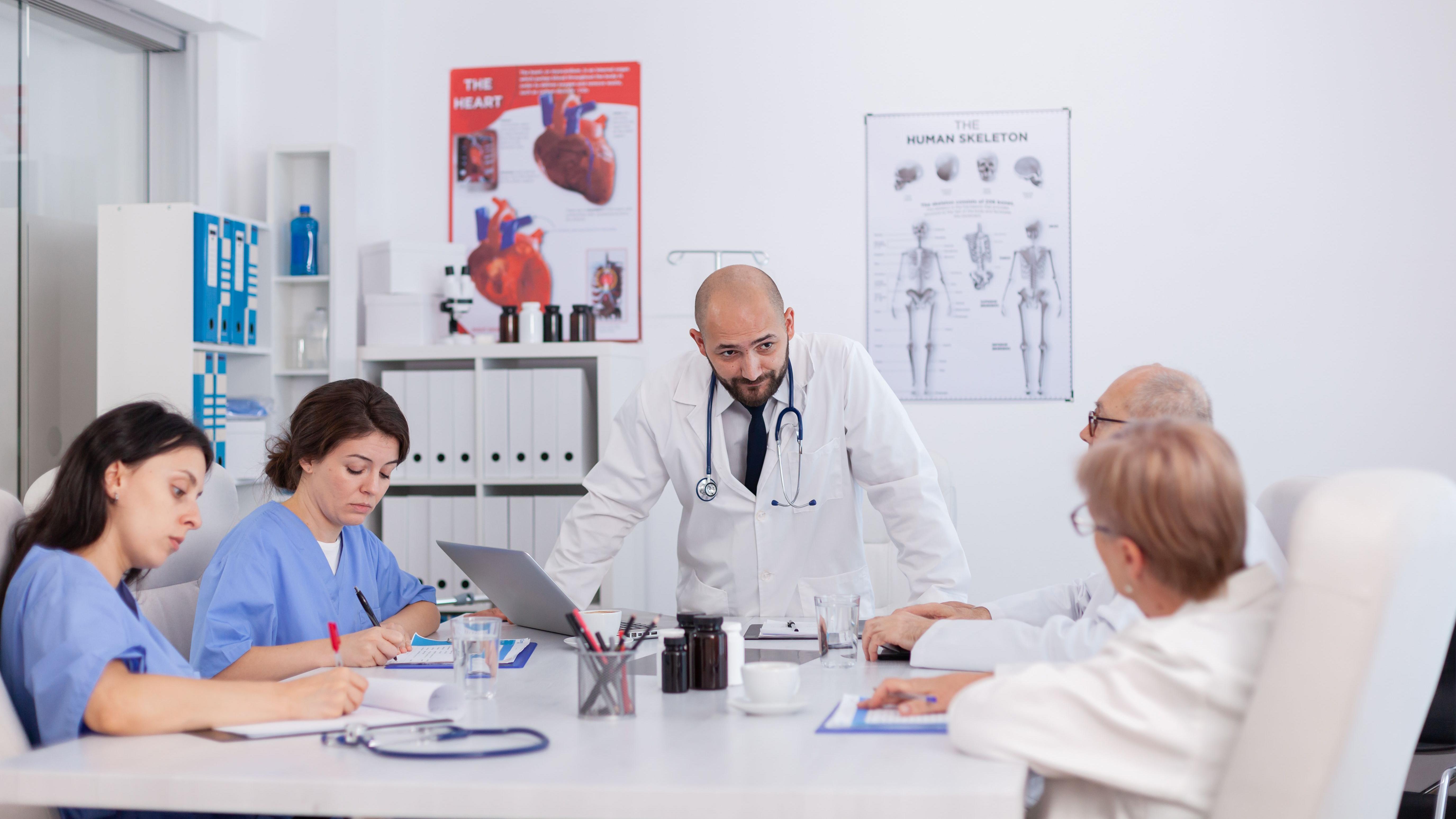 Therapist doctor with stethoscope explaining healthcare treatment discussing medical expertise