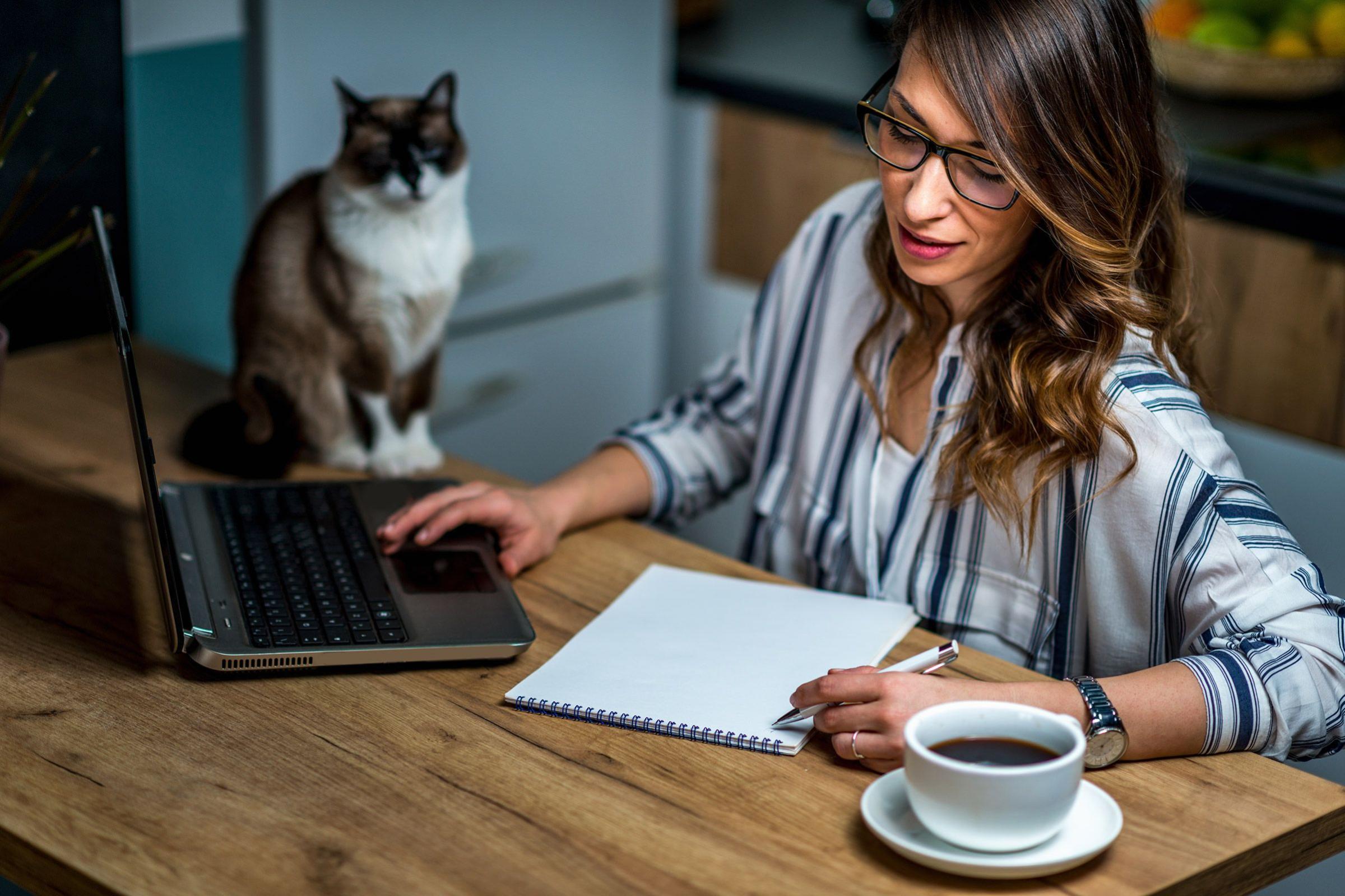 young-woman-drinking-coffee-and-working-at-home