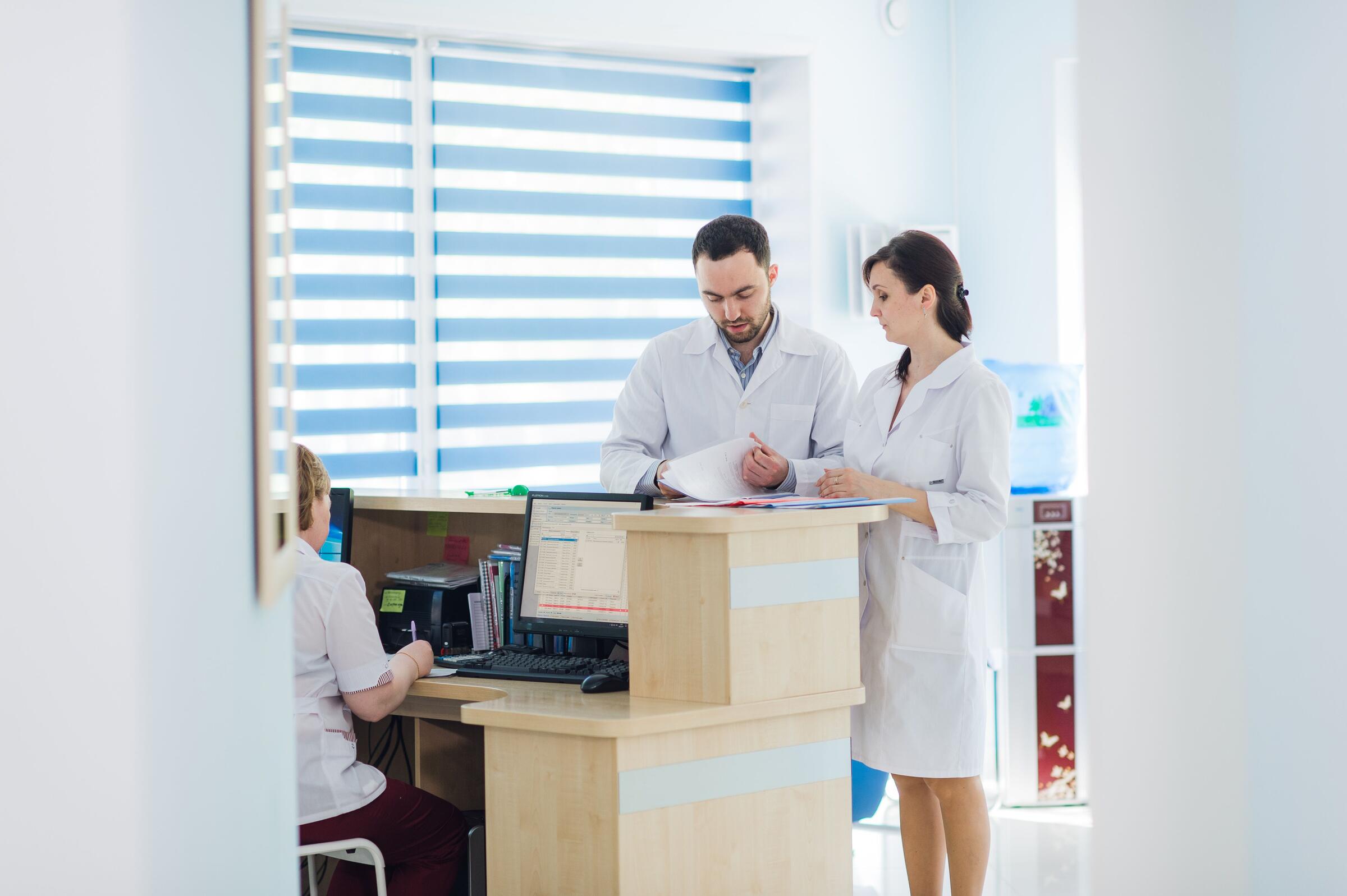 Busy reception in a hospital with doctors and receptionists