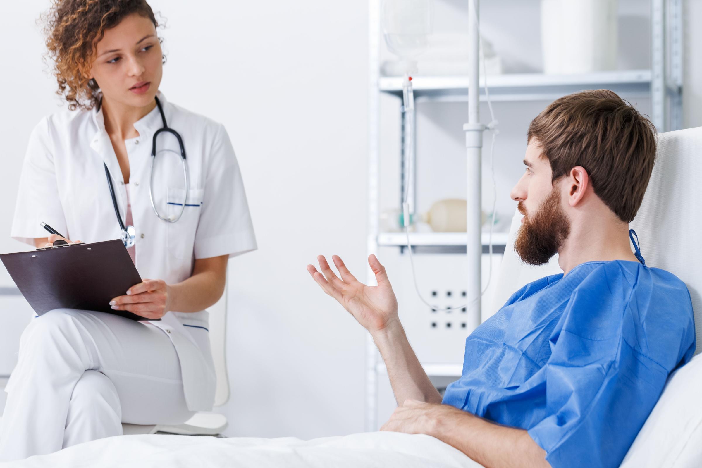 Trauma patient talking with nurse