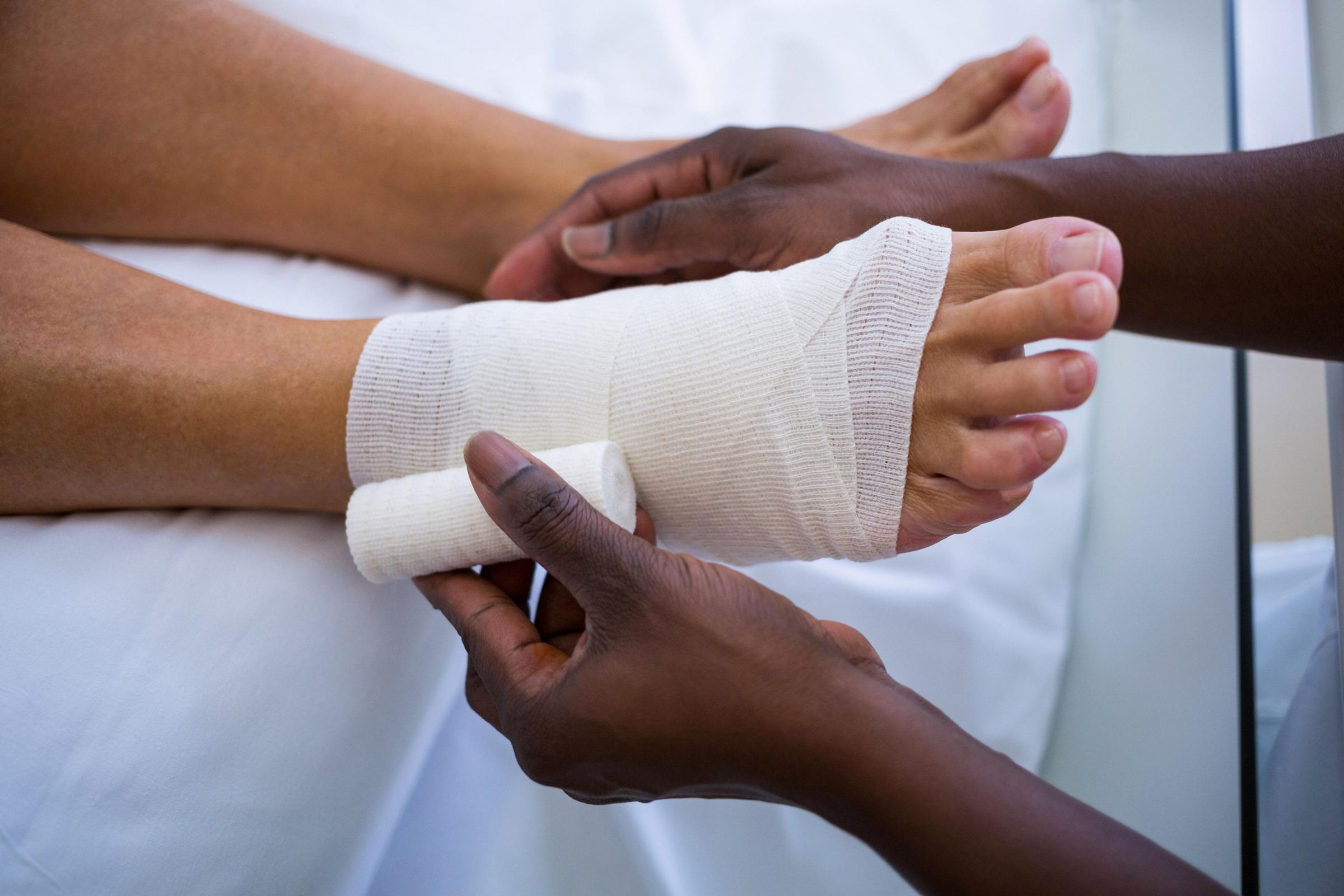 Doctor bandaging patients leg